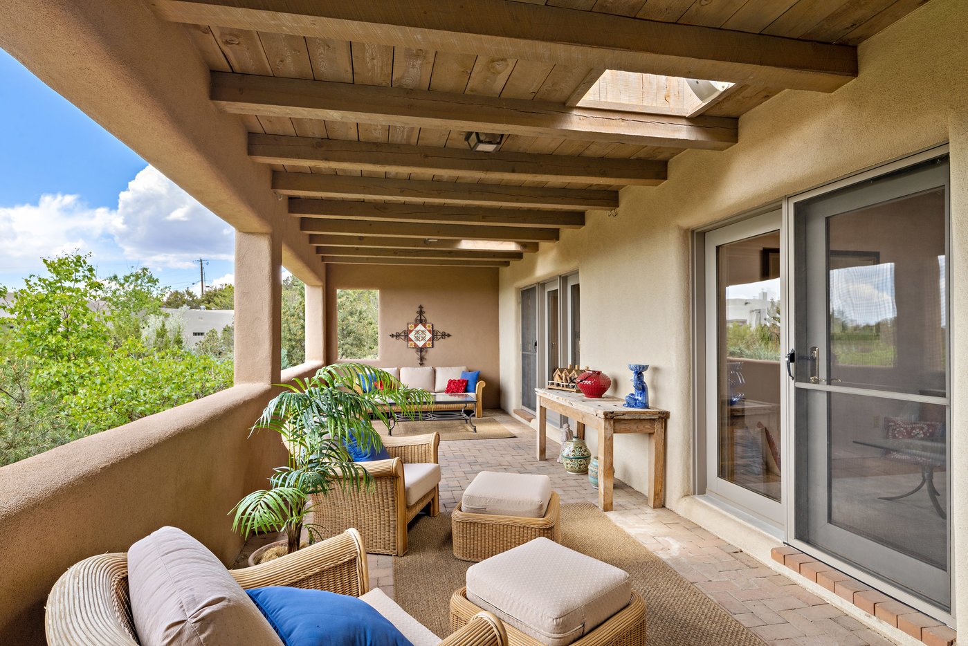 Exterior covered portal accessed from two guest bedrooms through glass doors